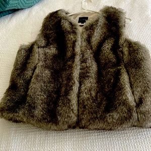 Item is faux fur vest. Like new! Has pockets The limited store.